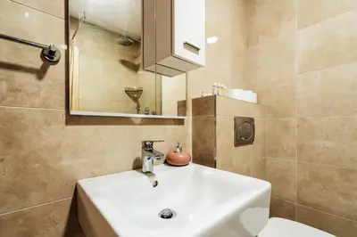 a bathroom with a sink and a toilet at Central studio by In Property in Budva