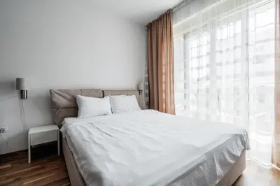 a bedroom with a large bed and a large window at Central studio by In Property in Budva