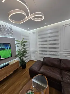 a living room with a couch and a tv at Rent a apartment Podgorica in Podgorica