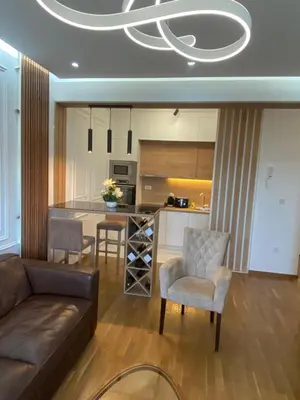 a living room with a couch and a kitchen at Rent a apartment Podgorica in Podgorica