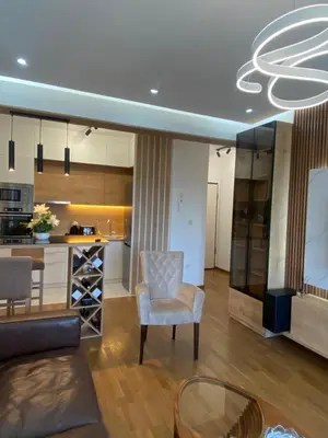 a living room with a couch and a chair and a table at Apartman Podgorica in Podgorica