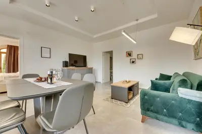 a living room with a table and a couch at Sutorman 1 Villa D&B in Zupci