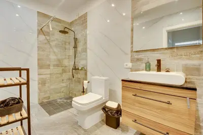 a bathroom with a toilet and a sink and a shower at Sutorman 1 Villa D&B in Zupci