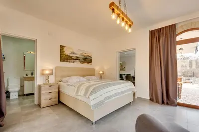 a bedroom with a large bed and a bathroom at Sutorman 1 Villa D&B in Zupci