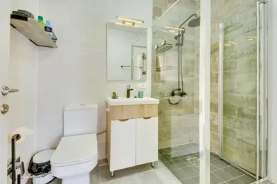 a white bathroom with a toilet and a shower at Sutorman 1 Villa D&B in Zupci