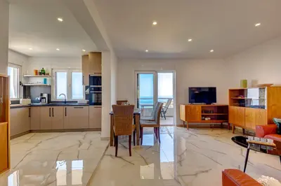 a kitchen and living room with a table and chairs at Jana in Utjeha