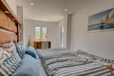 a bedroom with a large bed and a couch at Jana in Utjeha