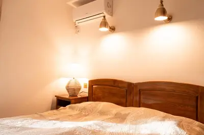 a bedroom with a bed and a lamp on a table at Historic Seafront Family Villa in Rafailovici