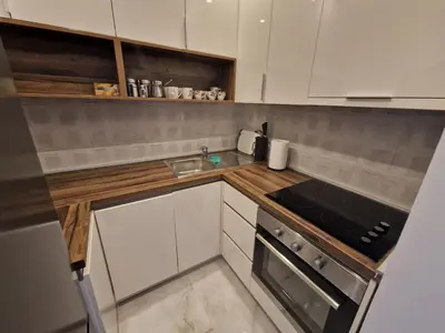 a small kitchen with a sink and a stove at Beach apartment Sveti Stefan in Sveti Stefan