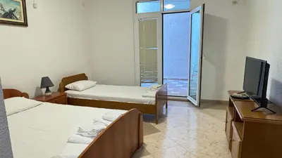 a hotel room with two beds and a television at Sea La Vie Apartments in Ulcinj