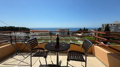 a table with a bottle of wine on a balcony at Sea La Vie Apartments in Ulcinj