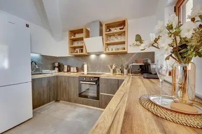a kitchen with a table with a vase of flowers at Sutorman 2 Villa D&B in Zupci