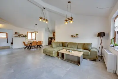 a living room with a couch and a table at Sutorman 2 Villa D&B in Zupci