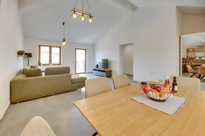 a living room with a table and a couch at Sutorman 2 Villa D&B in Zupci