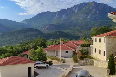 a view of a village with mountains in the background at Sutorman 2 Villa D&B in Zupci