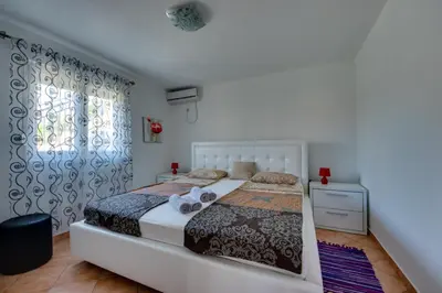 a bedroom with a bed and a window at Sun & Sea in Utjeha