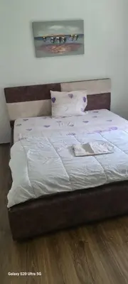 a bed with white sheets and pillows in a bedroom at Stan na dan Podgorica in Podgorica