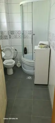 a bathroom with a shower and a toilet and a sink at Stan na dan Podgorica in Podgorica