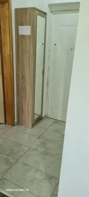 an empty room with two doors and a tile floor at Stan na dan Podgorica in Podgorica