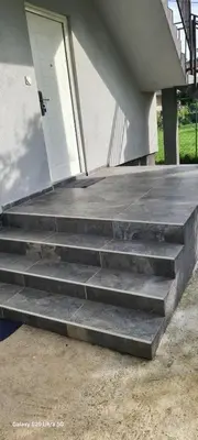 a set of concrete stairs in front of a house at Stan na dan Podgorica in Podgorica