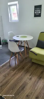 a living room with a table and a chair and a table at Stan na dan Podgorica in Podgorica