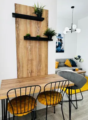 a dining room with a wooden table and chairs at Apartment for you in Bar