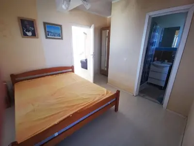 a bedroom with a bed and a bathroom at Villa Anlave in Sveti Stefan