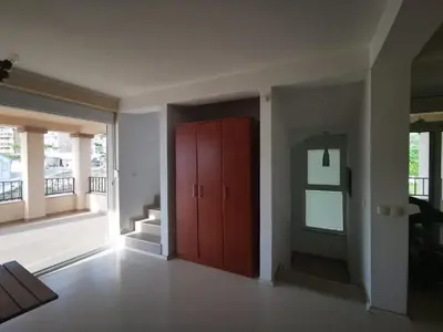 a living room with a red cabinet and a staircase at Villa Anlave in Sveti Stefan