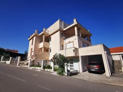 a building with a car parked in front of it at Villa Anlave in Sveti Stefan