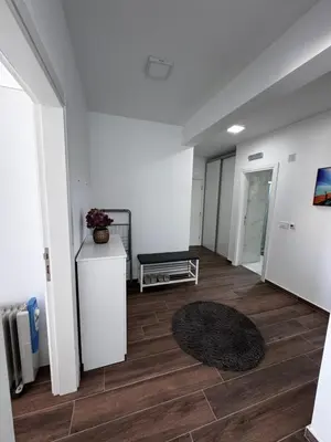 a hallway with a room with white walls and wood floors at Sarah in Bijela Glavica