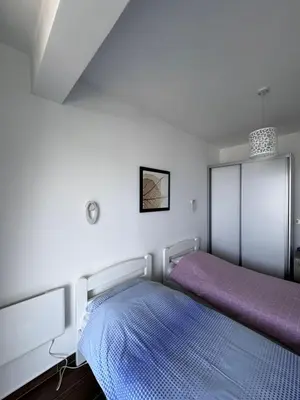 a bedroom with a bed with a purple blanket at Sarah in Bijela Glavica