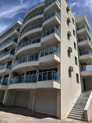 an apartment building with a parking lot at Sarah in Bijela Glavica