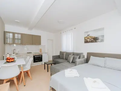 a living room with a couch and a table at Apartments Milivojevic in Bar