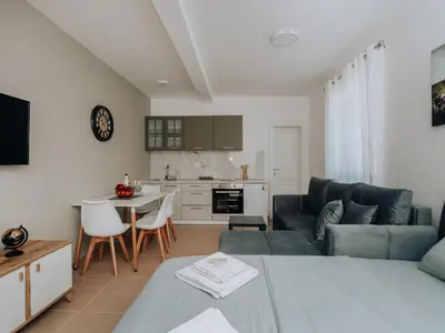 a living room with a couch and a table at Apartments Milivojevic in Bar