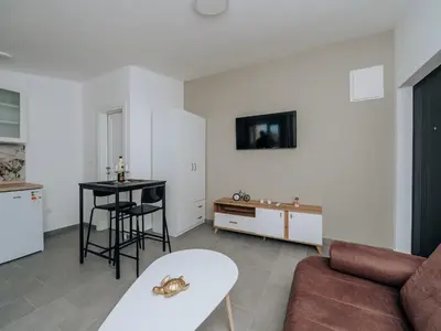 a living room with a couch and a table at Apartments Milivojevic in Bar