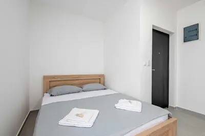 a bedroom with a bed with two towels on it at Apartments Milivojevic in Bar