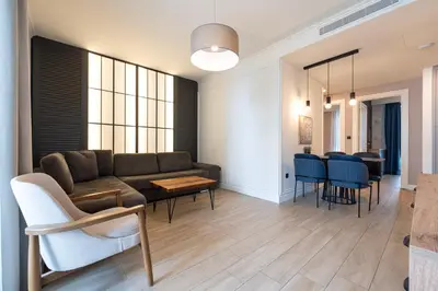 a living room with a couch and a table and chairs at Invictus Hotel in Budva