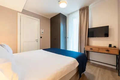 a hotel room with a bed and a television at Invictus Hotel in Budva