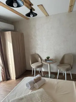 a bedroom with a bed and a table and chairs at Etno Selo Grabovicka Jutra in Cetinje