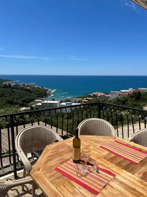 a table with a bottle of wine on top of a balcony at Villa Galatea in Utjeha