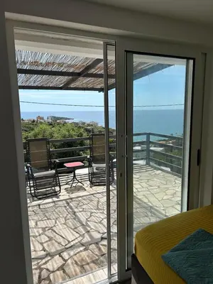 a bedroom with a view of the ocean from a balcony at Villa Galatea in Utjeha