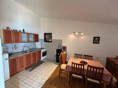 a kitchen with a table and a dining room at Villa Galatea in Utjeha