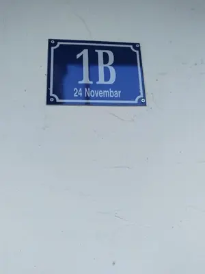 a sign on a wall with the number on it at D&D Apartman in Bar