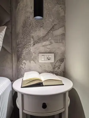 a table with an open book and a light switch at Sunny Hill - Parking - Fenced Garden - Luxury Loft in Kotor