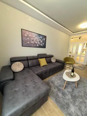 a living room with a couch and a table at Sunny Hill - Parking - Fenced Garden - Luxury Loft in Kotor