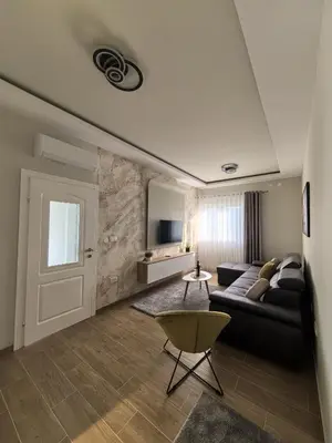 a living room with a couch and a table at Sunny Hill - Parking - Fenced Garden - Luxury Loft in Kotor