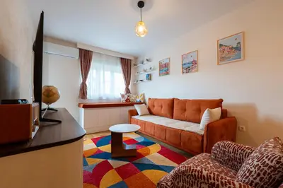 a living room with a couch and a table at Geppetto Apartment in Podgorica