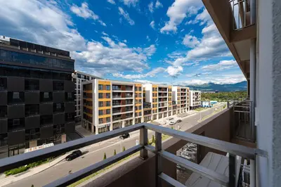 a balcony with a view of a street and buildings at Geppetto Apartment in Podgorica