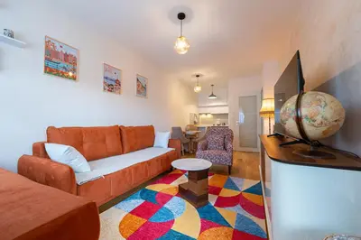 a living room with a couch and a table at Geppetto Apartment in Podgorica