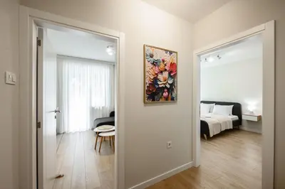a room with a bed and a painting on the wall at Lux Apartment 88 in Kotor